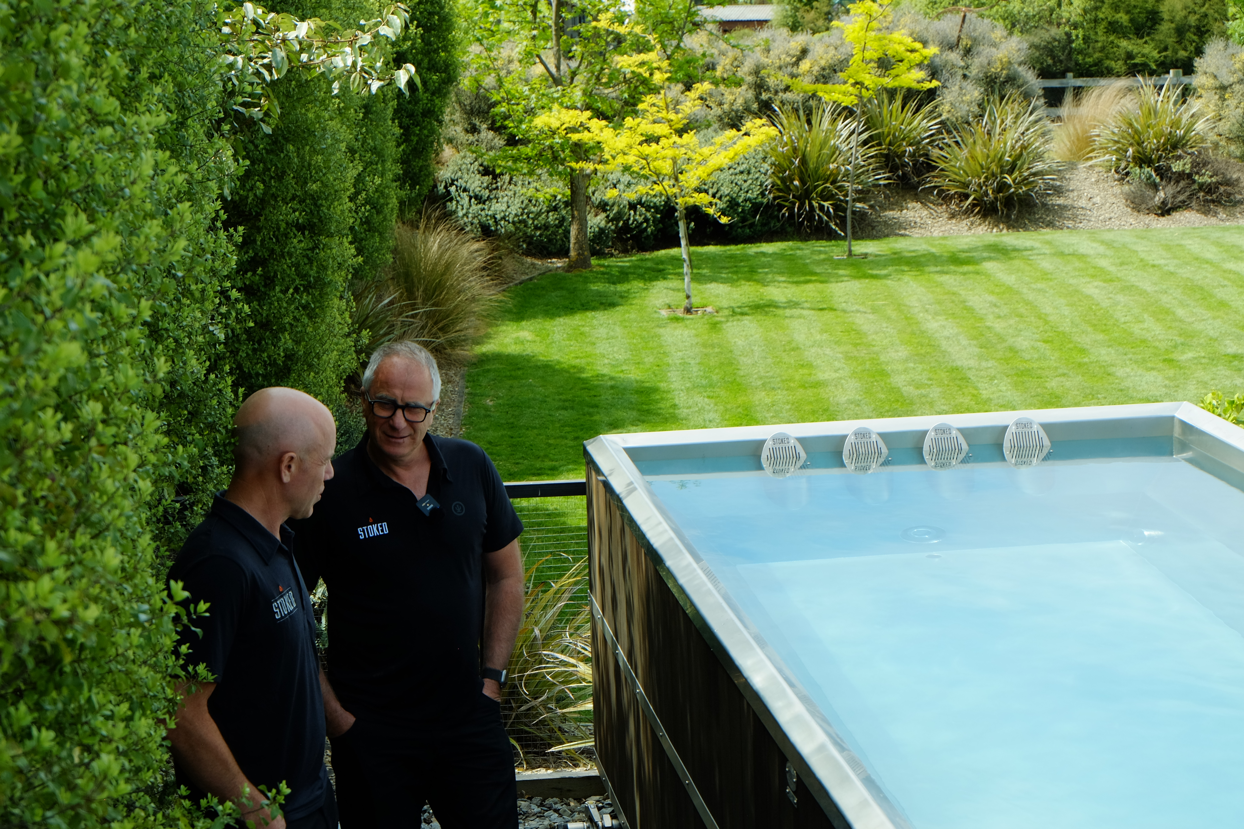 Stoked founders beside a pool