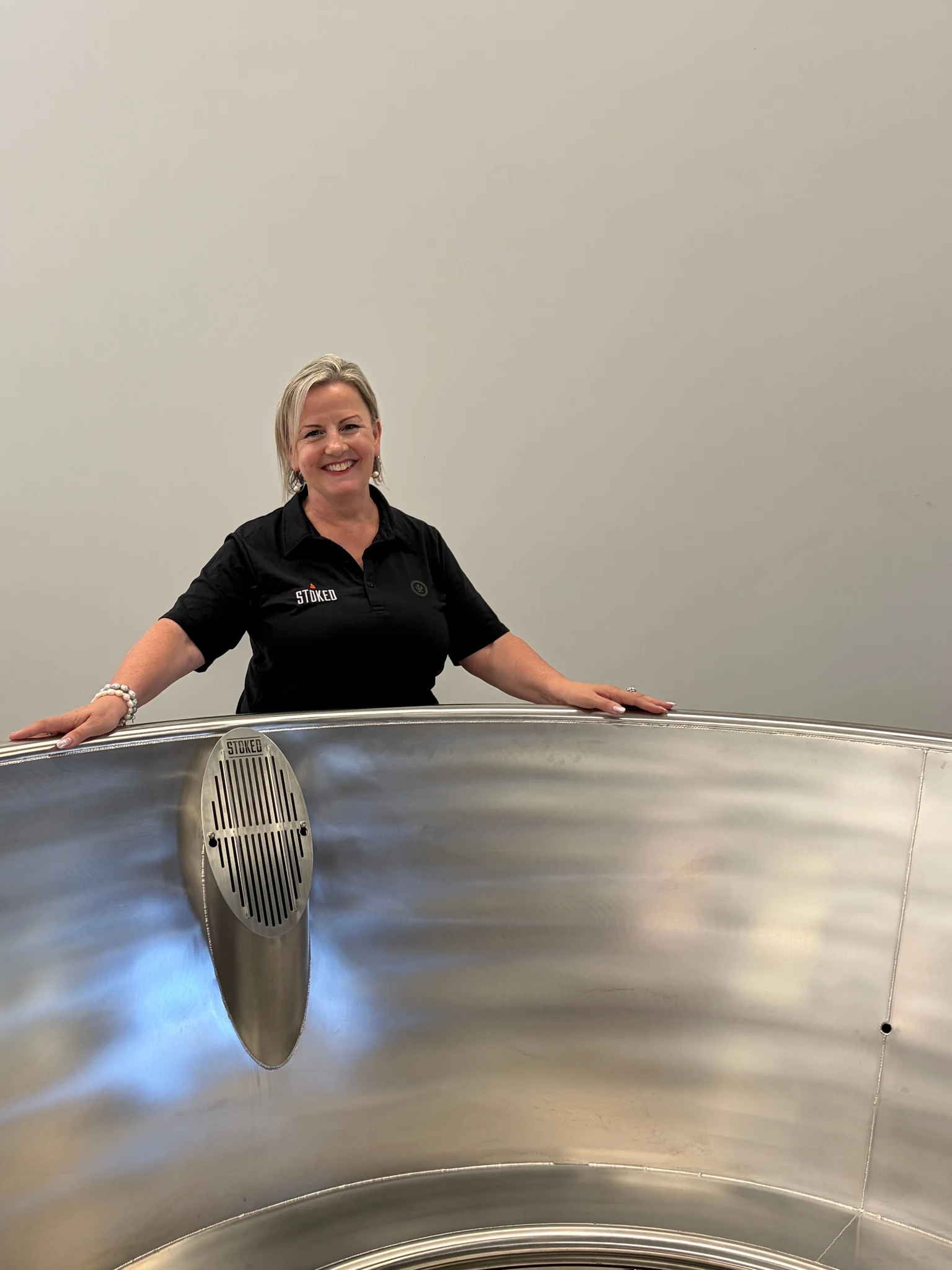 A Stoked team member beside a stainless steel tub