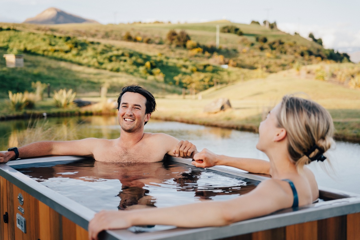 Two people enjoying a Stoked outdoor spa